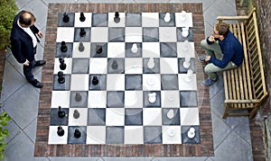 Two men playing a game of outdoor chess