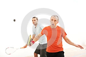 Two men playing match of squash.