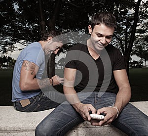 Two men playing with their phones