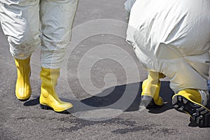 Two men in protective gear disinfecting contaminated areas