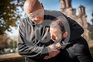 Two men quarrel and fight. Two thugs are fighting