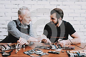 Two Men Repairing Hardware Equipment from PC.