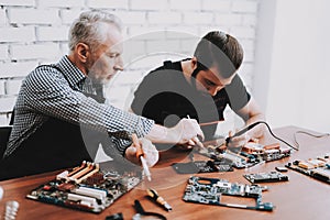 Two Men Repairing Hardware Equipment from PC.