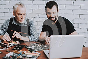 Two Men Repairing Hardware Equipment from PC.