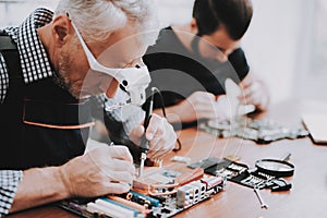 Two Men Repairing Hardware Equipment from PC.