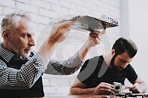 Two Men Repairing Hardware Equipment from PC.