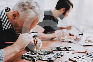 Two Men Repairing Hardware Equipment from PC.