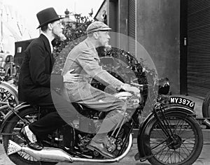 Two men riding a motorbike