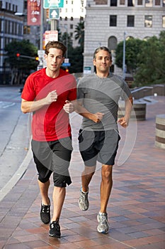 Two Men Running On Urban Street