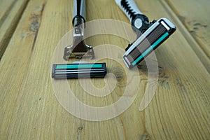 Two men`s razors with replaceable cartridges are on the table