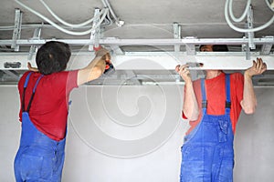 The two men set the ceiling profile in the