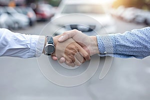 Two men shake hands in front of a car by AI generated image