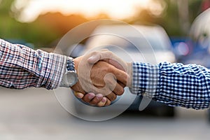 Two men shake hands in front of a car by AI generated image