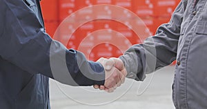 Two men shake hands. Handshake of two men close-up. Factory shaking hands, concluding a successful deal