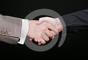 Two men shaking hands over black