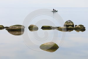 Two men silhouette in a boat.