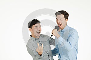 Two men singing karaoke pose