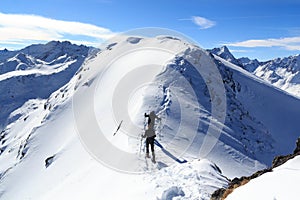 Two men snowshoe hiking on mountain snow arete and panorama in Stubai Alps photo