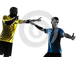 Two men soccer player and referee standing silhouette