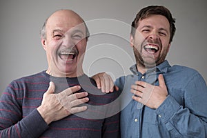 Two men and son laughing on their friend joke having a good mood.