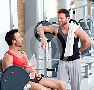 Two men on a sport gym relaxed after fitness