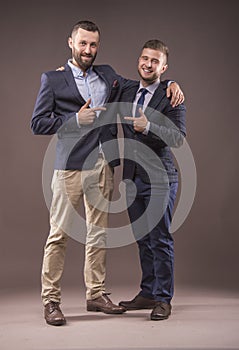 Two men in suits hugging