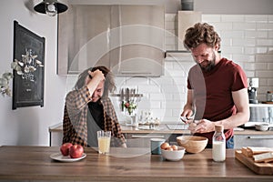 Two men talking in the kitchen