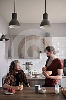 Two men talking in the kitchen