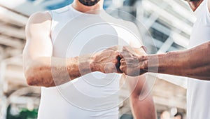 two men used the fist bump to express teamwork