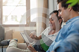 Two Men Using Tablet Computer at Cafe, Friends