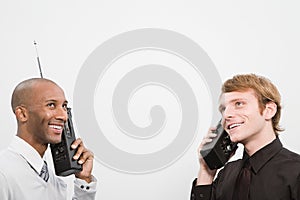 Two men using walkie talkies