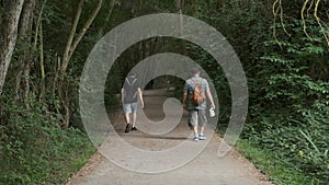 Two men walking along a path in Salburua park in Vitoria-Gasteiz, Spain.