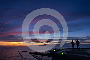 Two men walking on oil rig helipad