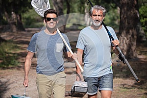 two men walking towards fishing place