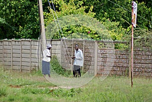 Two men by a wall in Harare