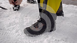 Two men went on an expedition. Professional trekking boots and leggings help to move in the snow.