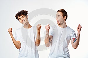 two men in white t-shirts are standing next to friendship emotions