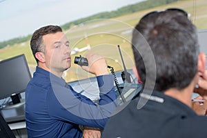 Two men working in airport control tower