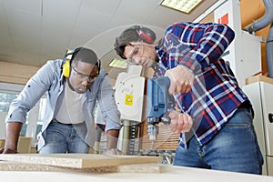 Two men working with boards in workshop