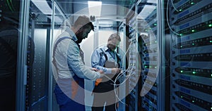 Two men working in a data center