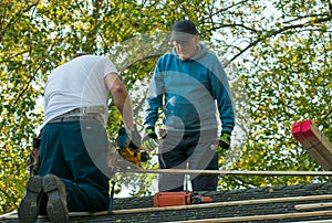 Two men working on the roof