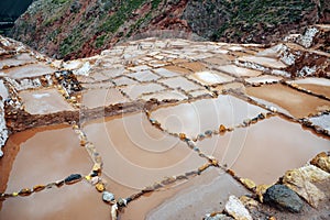 Two men working at salt ponds in Maras, Cuzco, Sacred Valley