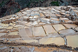 Two men working at salt ponds in Maras, Cuzco, Sacred Valley