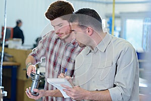 Two men working together in workshop