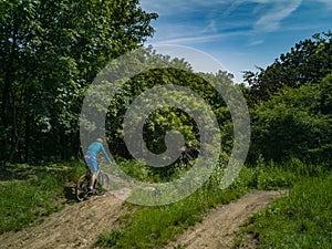 Two mens at edge of hill ride downhill in park