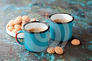 Two metal enameled coffee mugs