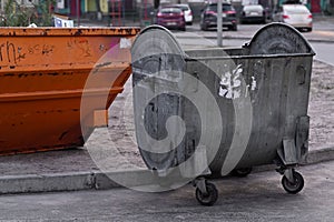 Two metal garbage cans. unsorted garbage. Unsorted garbage. in city yard