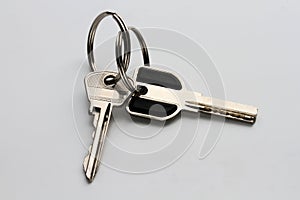 two metal keys on a homogeneous gray background