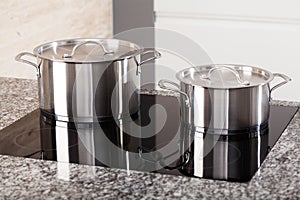 Two metal pots on induction hob photo