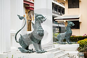 Two metal security dogs in buddhistic temple